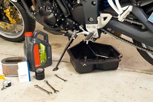 Photo of some tools sitting underneath a motorcycle