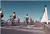 An image of cyclists on a bridge.