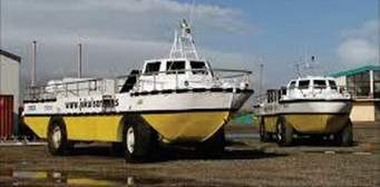 Photograph of 2 amphibious vehicles parked on the ground