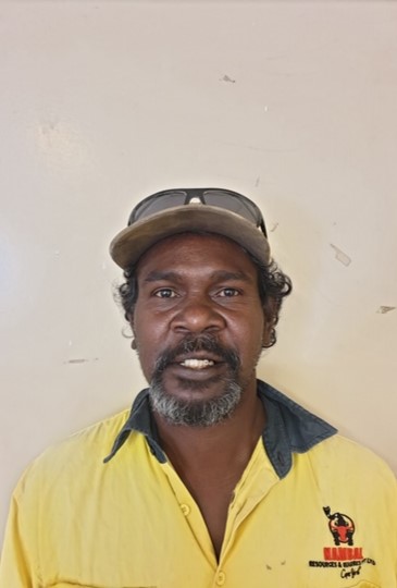 A person in a yellow shirt with sunglasses