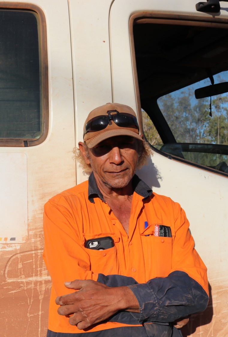 A person sitting in high vis gear
