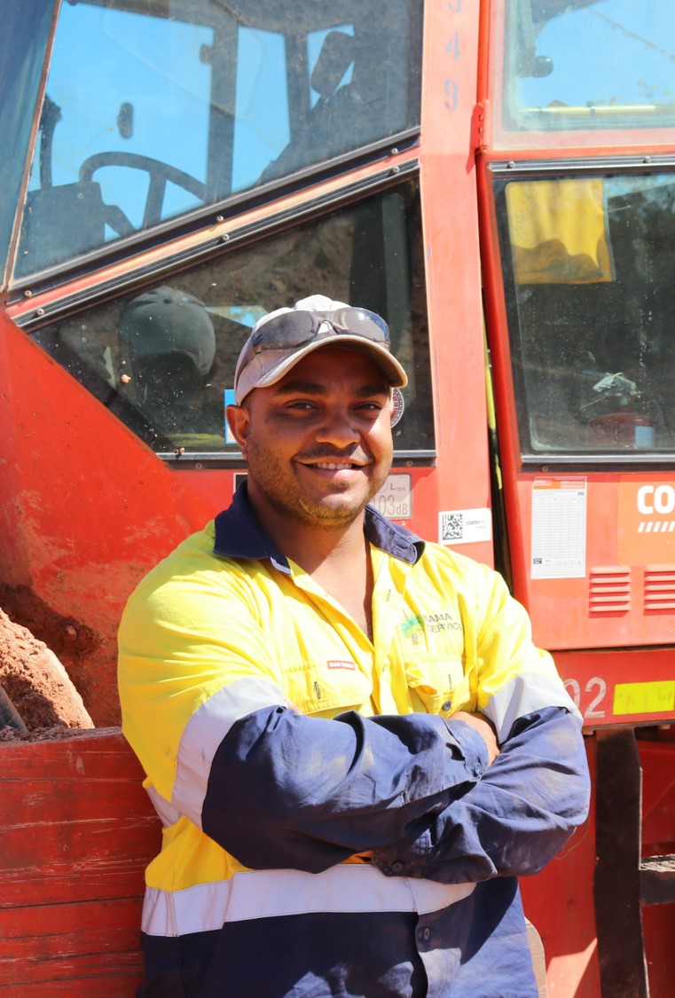 A person standing in front of road equipment