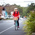 Person in a red jacket riding a bicycle