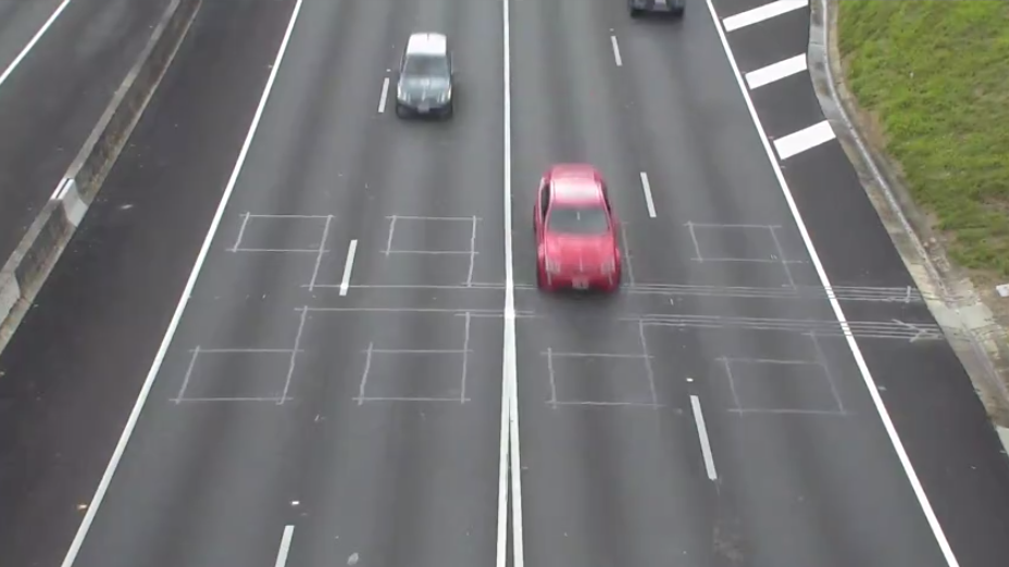 Markings on the road indicate the location of the vehicle detectors embedded in the road surface
