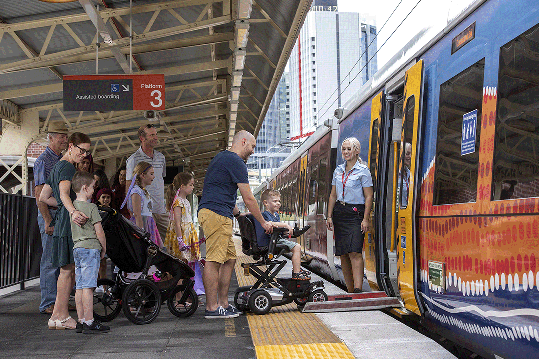 Customers boarding a train at an assisted boarding platform