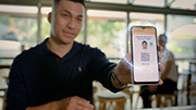 Customer holding app showing QR code