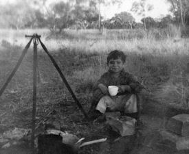 Image of a young boy drinking a roadside cup of tea near Kynuna.