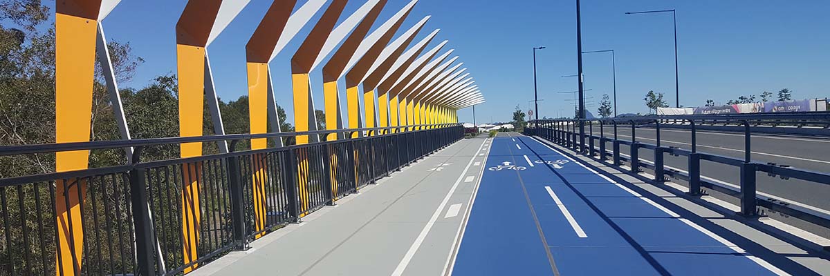 A bike path adjacent to a walking path and a road.