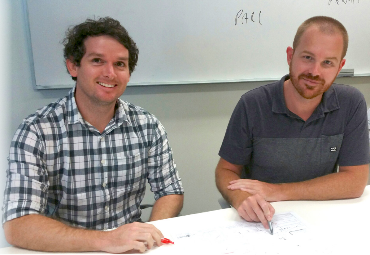 Intern working at a desk with his supervisor