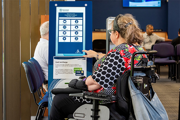 Customer in powered wheelchair using TMR customer service centre