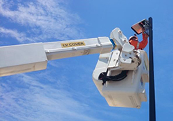 Workers installing street lights.