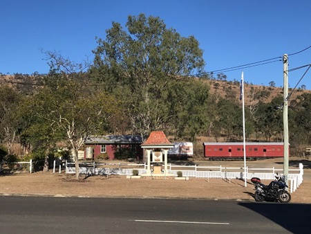 Accommodation with a motorcycle at the front and a train at the back