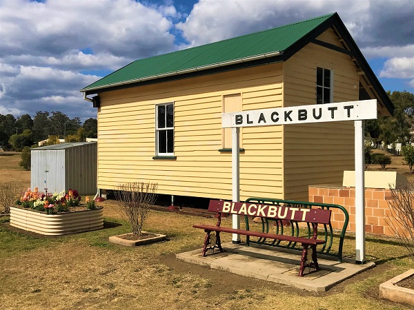 Image of a building with a sign and bench marked 'Blackbutt'