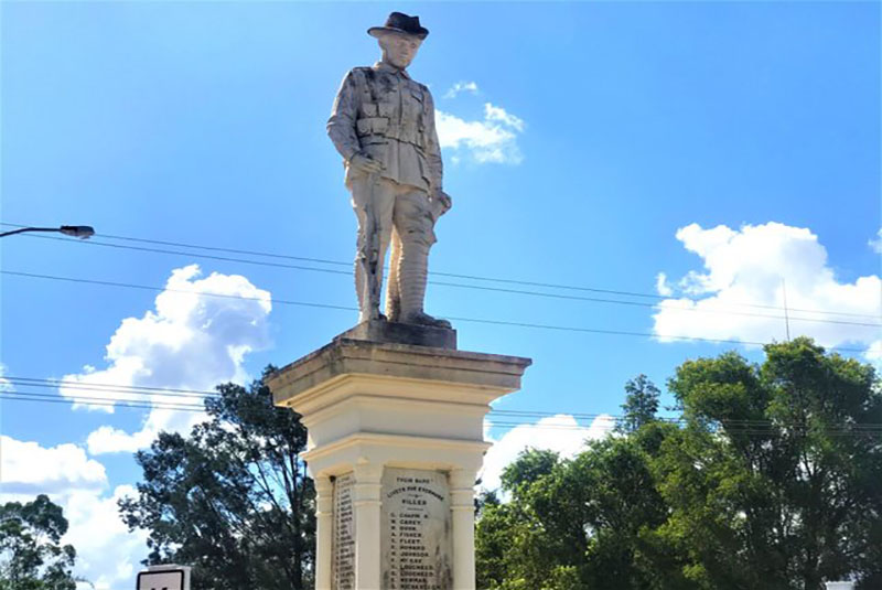 A statue of a soldier standing on top of a pillar