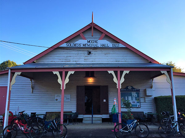 A building with a sign that says "Moore Soldiers Memorial Hall 1922" and bicycles out front