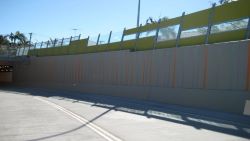 Plastic panels on a roadside noise barrier.