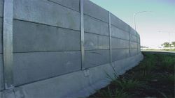 Steel absorptive panels used on a roadside noise barrier.