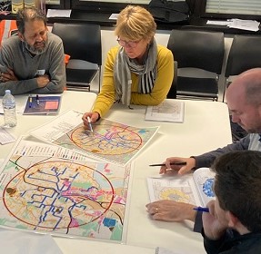 People sitting looking at walking network planning map