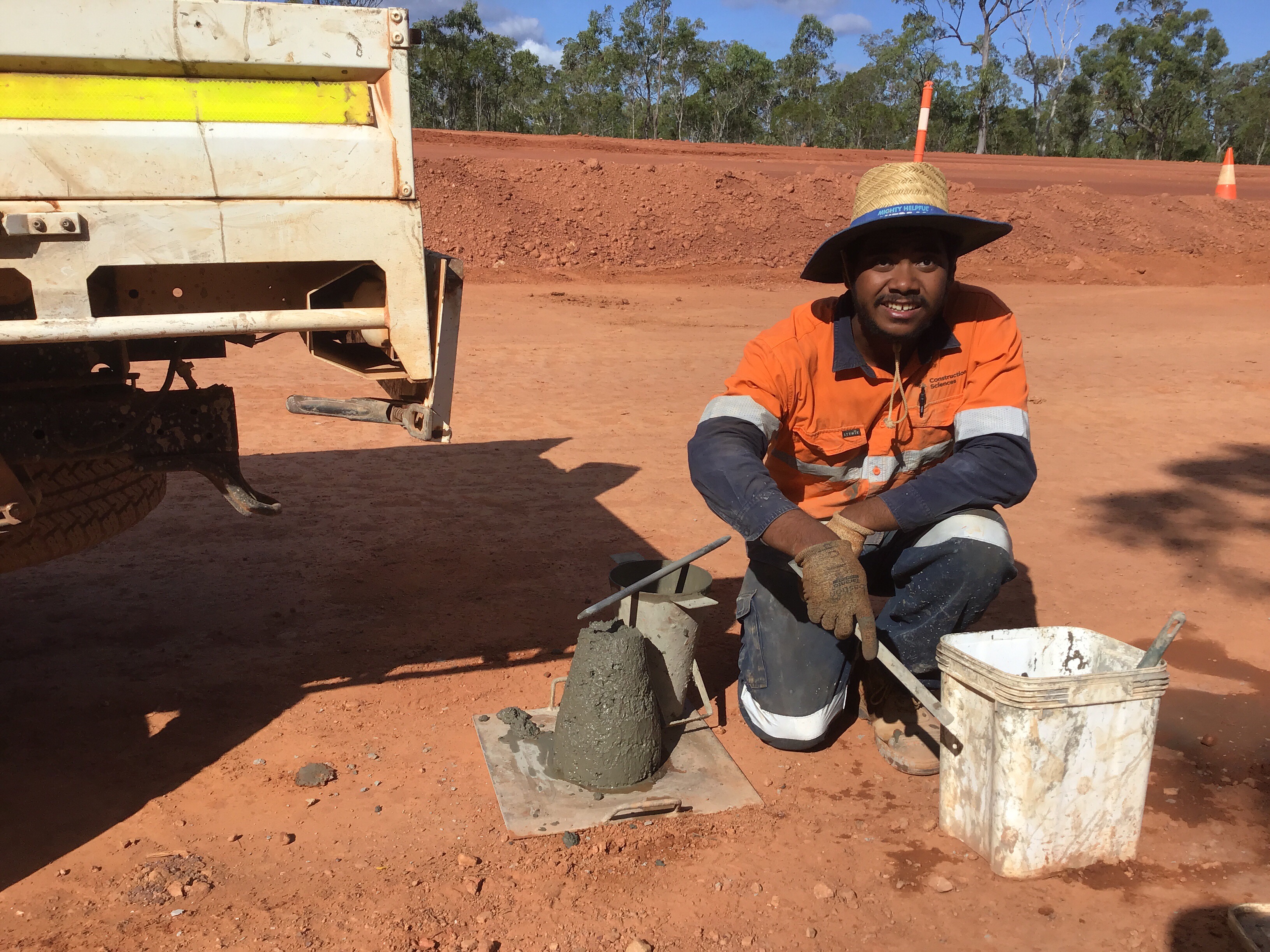 A person on the side of the road testing soil