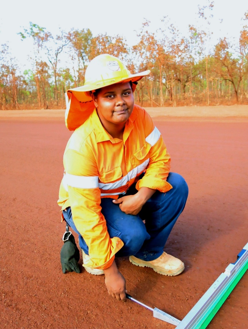 Person kneeling in high vis gear