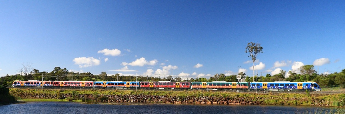 A New Generation Rollingstock train (with indigenous 'Travelling' artwork wrap) on the Gold Coast line.