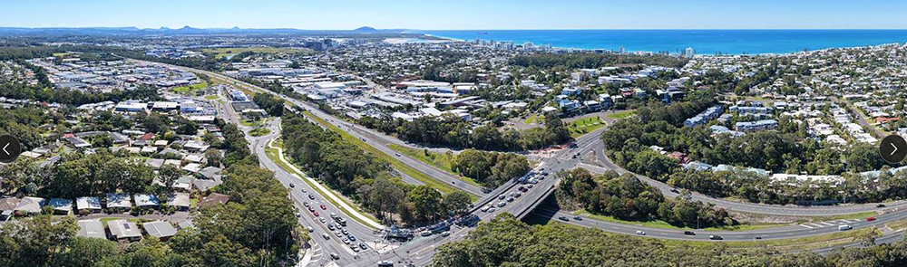 Overhead view of large intersection with traffic near the coastline.