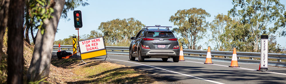 Car stopped for roadworks at a temporary red light