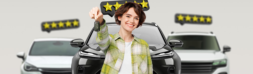 Smiling person holding car keys in front of cars with 5-star safety ratings displayed above them
