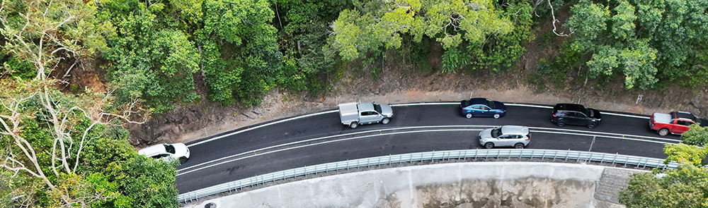 Cars on a road surrounded by trees