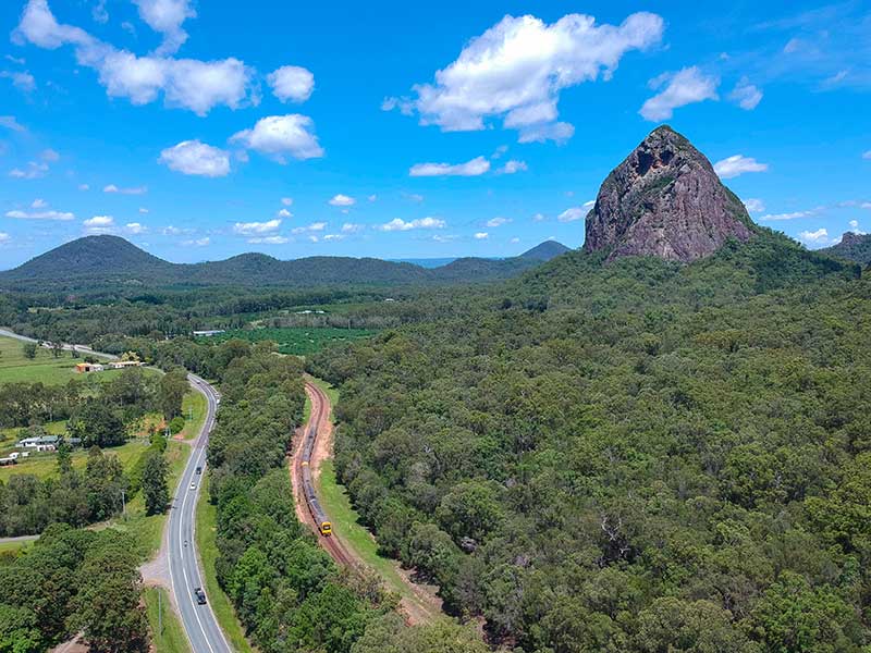The North Coast Line meanders through the Glass House Mountains