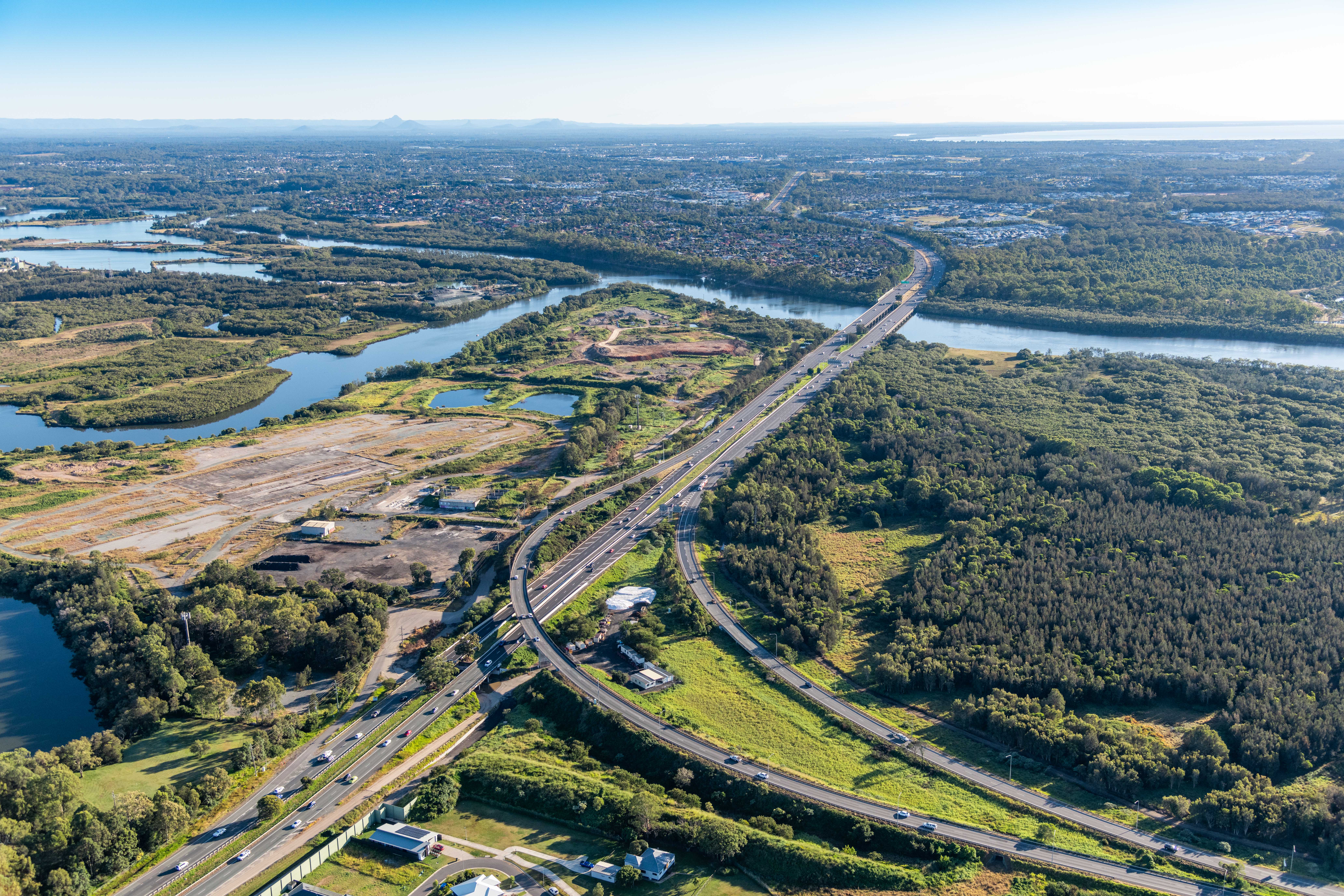 Bruce Highway Brisbane Gympie Gateway Motorway to Dohles Rocks Road upgrade funding commitment aeri Aerial view of road, trees, cars and houses