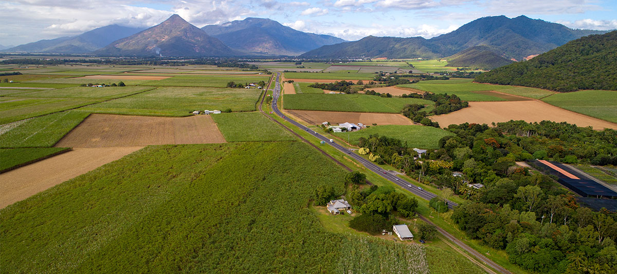 Overhead shot of road with surrounding land, mountains