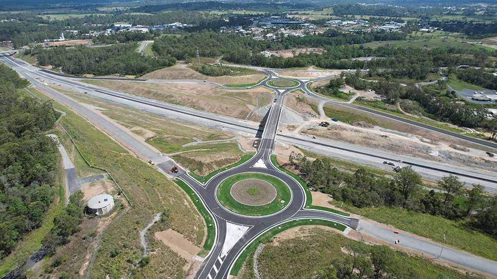 Aerial view of overpass between to large roundabouts. 