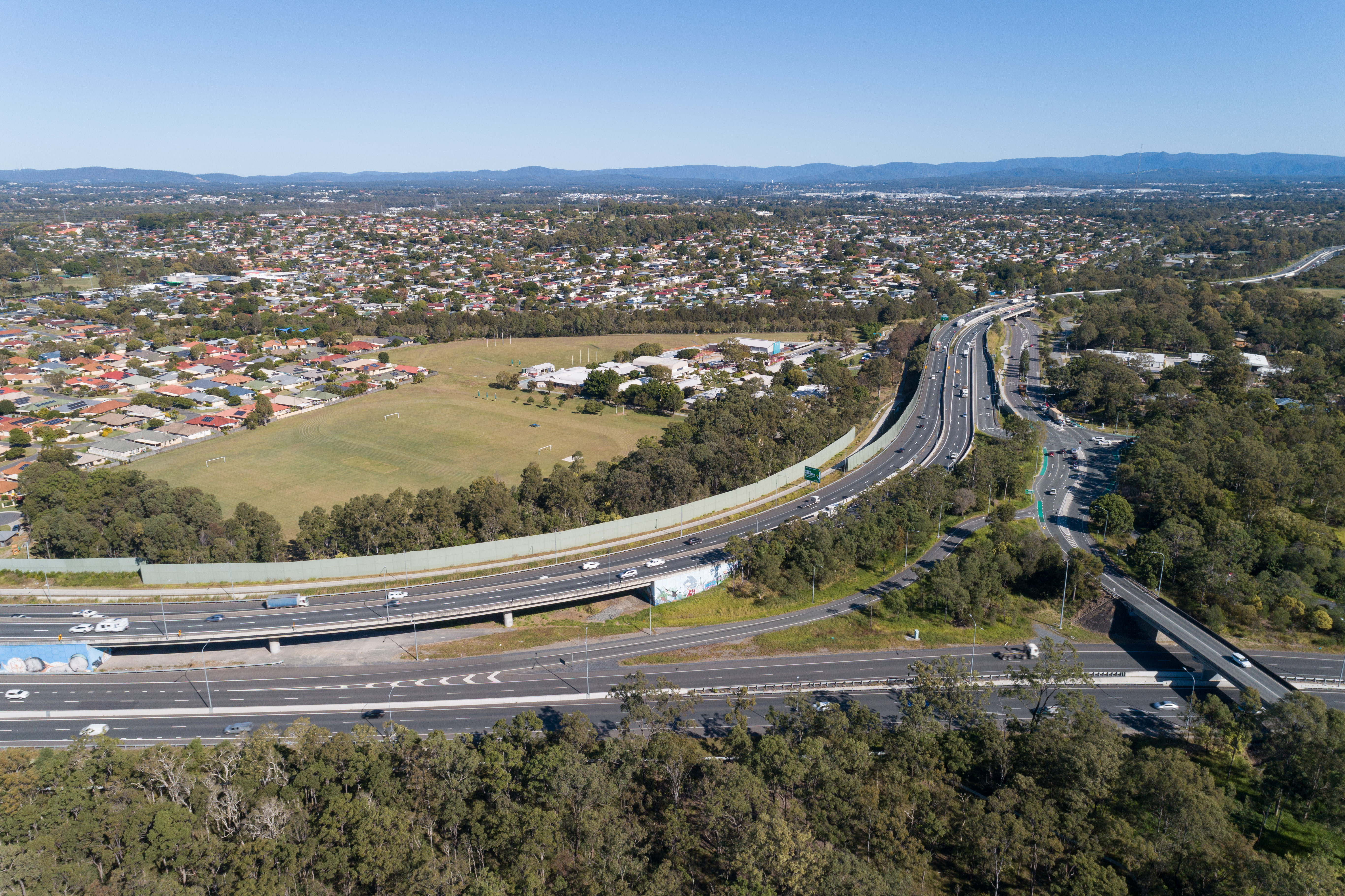 Aerial view of roads, cars, trees and houses