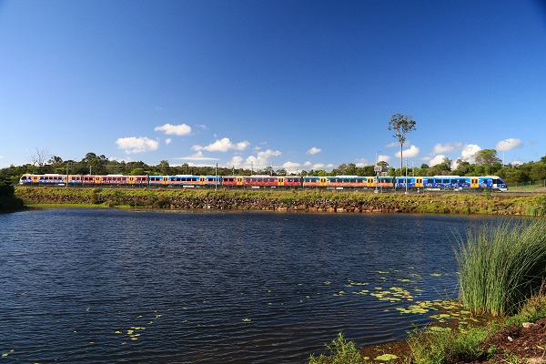 A train next to a body of water