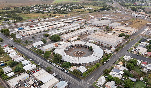 Rockhampton Railyards site Aerial view of the Rockhampton Railyards site featuring the circular roundhouse at the centre, surrounded by old storage sheds and rail tracks.