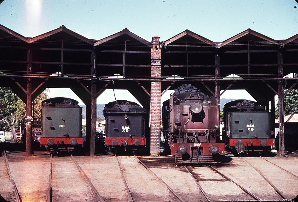 Steam train and trailers parked in the Roundhouse Rockhampton Railyards 1966 Historic image of a steam train and trailers parked in the circular roundhouse at Rockhampton Railyards 1966.