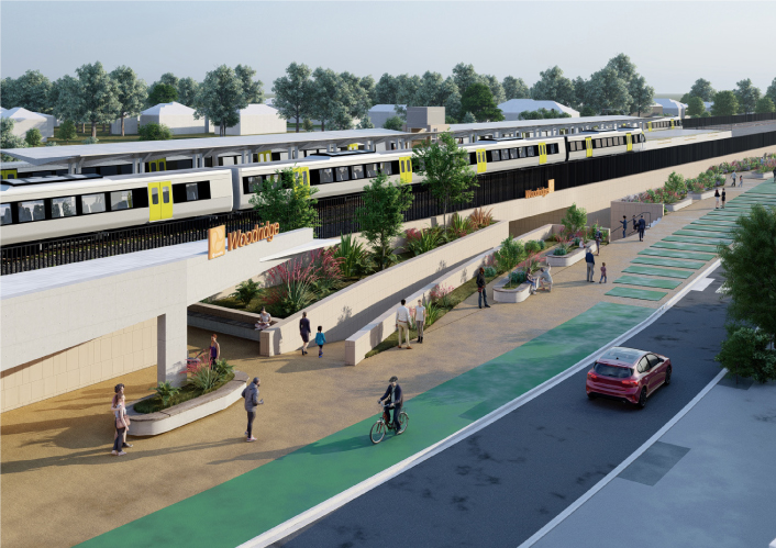 Artist impression of the proposed upgraded Woodridge station with the Translink logo and Woodridge sign on the front. Image is looking from Station Road and shows the new wider underpass with people out the front of the new station building and trains pulled up at the platforms.