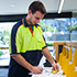 Man filling out form and holding licence in service centre