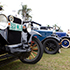 Multiple vintage cars parked on grass