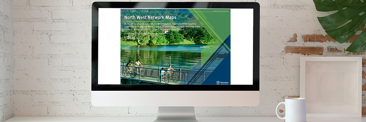 A computer screen showing a picture of a family on bikes on a bridge, with text North West Network Maps