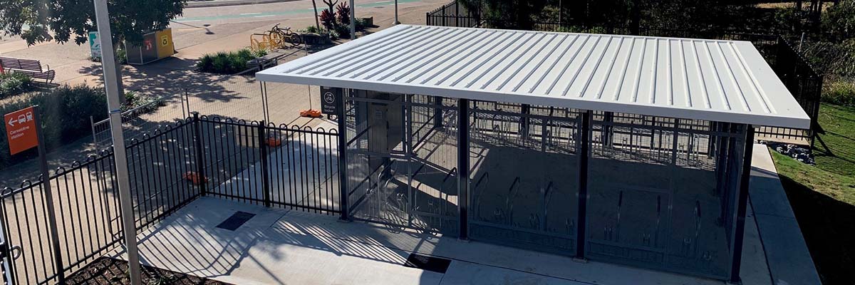 View from an overhead angle of a roofed, caged area with bike racks inside