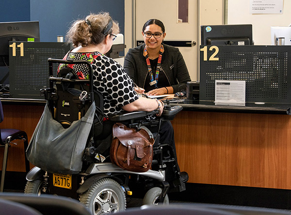Customer in wheelchair at customer service counter