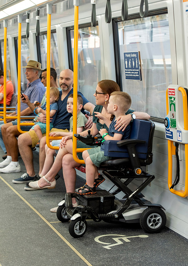 Family on train with child in wheelchair designated area