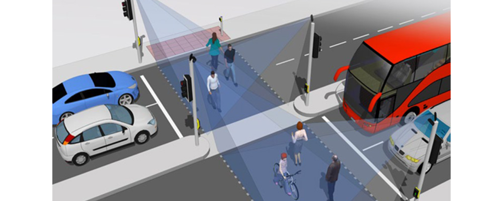 An example of a smart pedestrian crossing from the AGD 326 Product Manual. People are safely crossing the road as cars and buses wait.