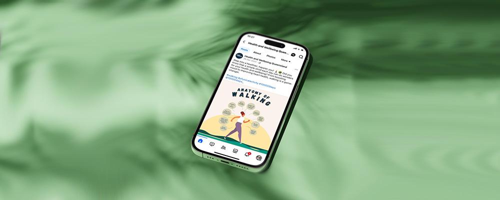 A mobile phone displaying a social media post on the anatomy walking by the Health and Wellbeing Queensland. Words displayed on the screen are 