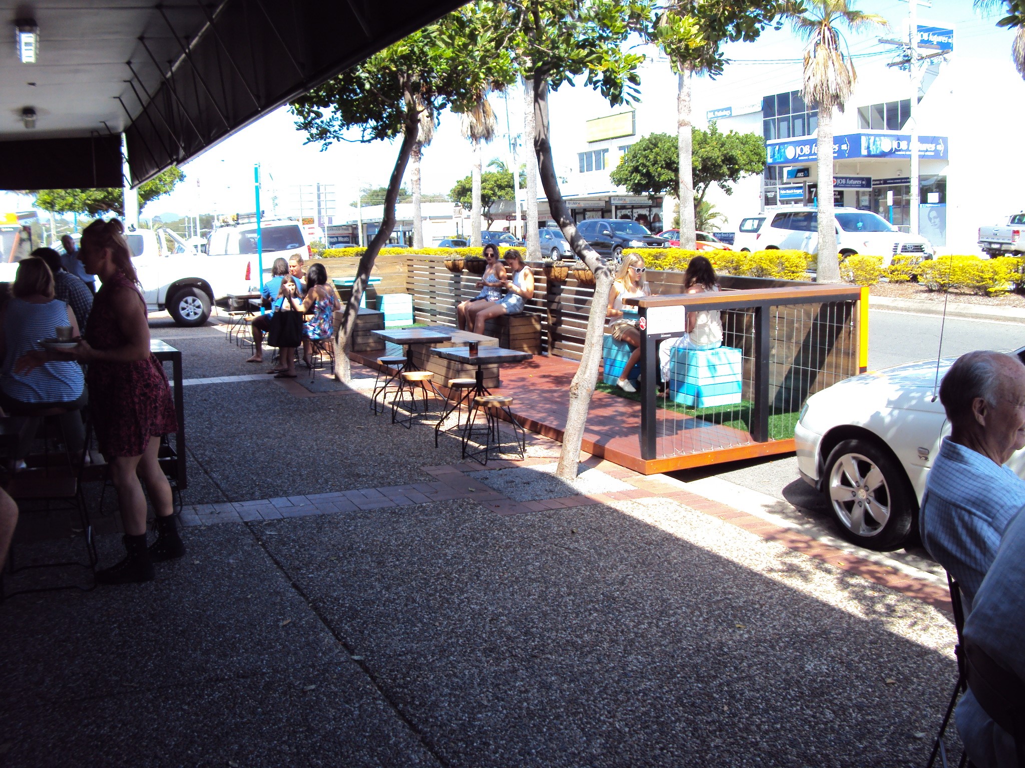 A temporary timber deck replaces three parking bays and creates more public space and seating: Palm Beach, City of Gold Coast 