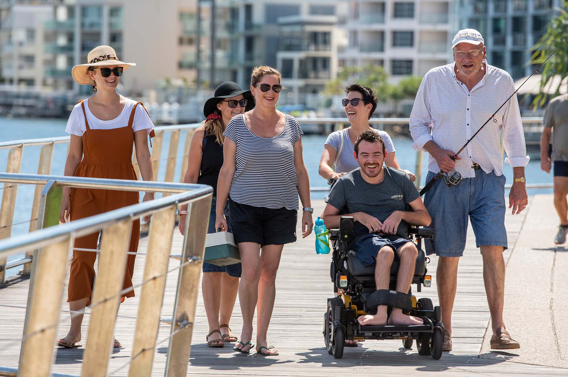 Group of people walking along a boardwalk