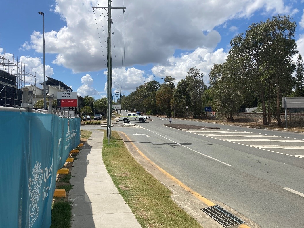 Photograph of road, footpath and land for proposed relocation of Loganlea station on Armstrong Road